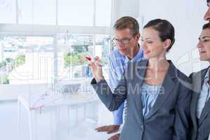 Businesswoman drawing graph on the board