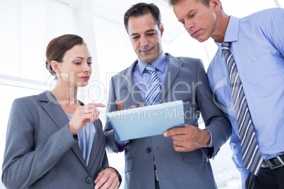 Businessman showing tablet to his colleagues