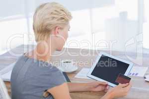 Businesswoman holding credit card and tablet
