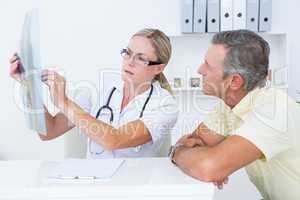 Doctor showing X rays to her patient