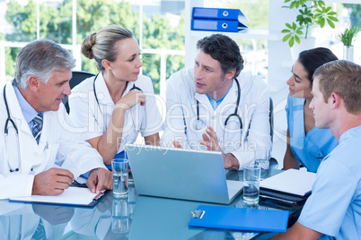 Team of doctors working on laptop