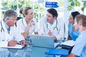 Team of doctors working on laptop