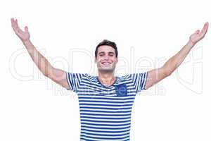 Handsome hipster smiling at camera with arms outstretched