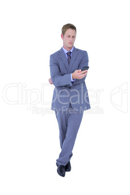 Handsome businessman texting on phone