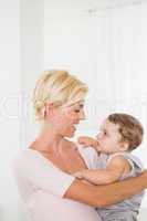 Smiling blonde woman with his son