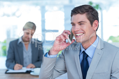 Smiling businessman having a phone call