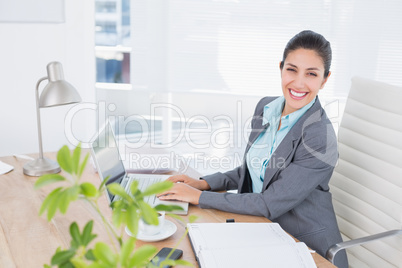 Smiling businesswoman using her computer