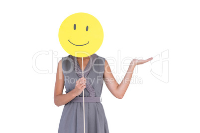 Businesswoman holding happy smiley face