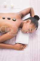 Pretty woman enjoying a hot stone massage