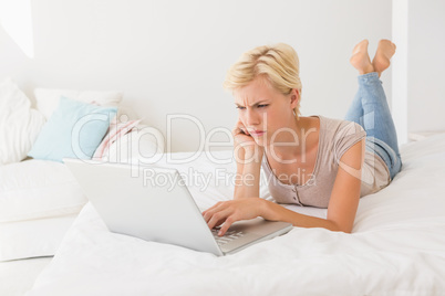 Serious blonde woman using laptop Serious blonde woman using laptop