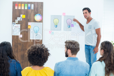 Creative business people at work by blackboard