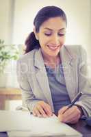 smiling businesswoman looking at camera