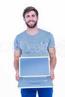 Happy handsome man holding laptop