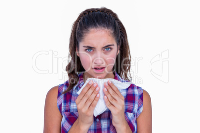 Pretty brunette woman blowing her nose