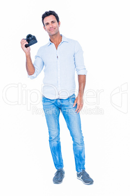 Handsome man holding photo camera