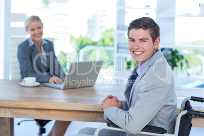 Disabled businessman working with partner