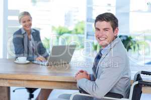Disabled businessman working with partner
