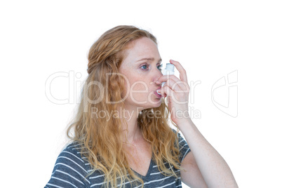 Pretty blonde using an asthma inhaler