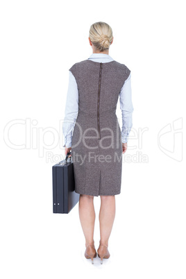 Back turned businesswoman holding a briefcase