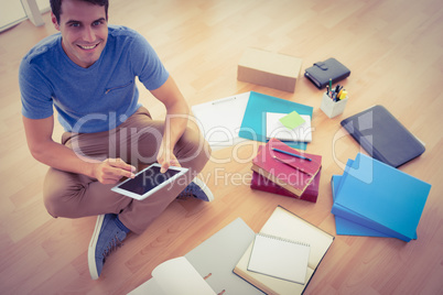 Young businessman working on the floor with tablet