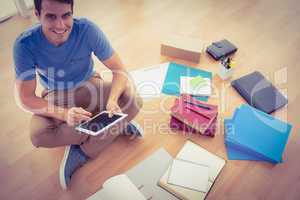 Young businessman working on the floor with tablet