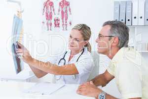 Doctor showing X rays to her patient