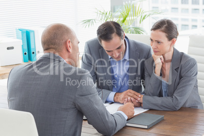 Businessman explaining contract to business partners