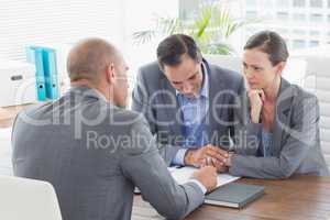 Businessman explaining contract to business partners