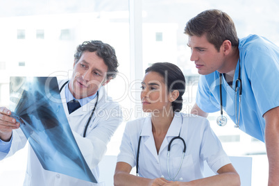 Team of doctors analyzing xray