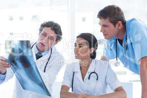 Team of doctors analyzing xray