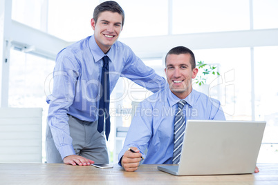 Businessmen using laptop