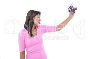 Pretty brunette taking a selfie with retro camera