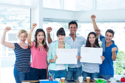 Happy business team holding a signboard