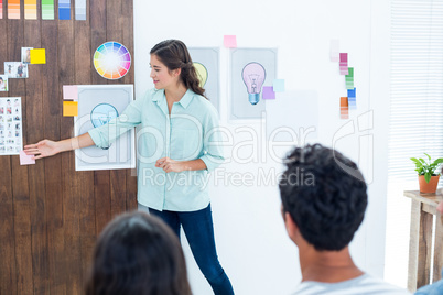 Casual young businessman giving presentation to colleagues