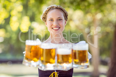 Pretty oktoberfest blonde holding beers