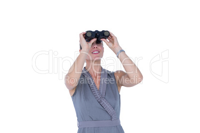 A businesswoman looking through binoculars