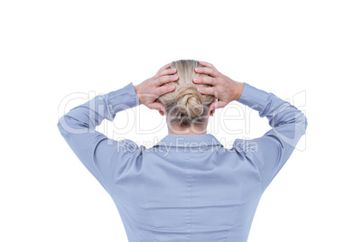 Rear view of worried businesswoman holding her head