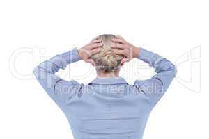 Rear view of worried businesswoman holding her head