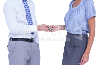 Businessman giving bank notes to his colleague