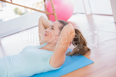 Woman lying on exercise mat