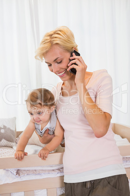 Smiling blonde woman with his son phoning