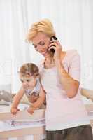 Smiling blonde woman with his son phoning