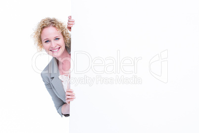 Woman looking around blank sign