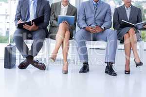 Business people waiting to be called into interview