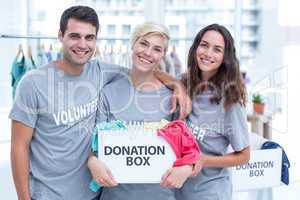 Volunteers friends holding a donation box