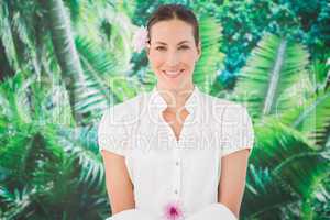 Smiling beauty therapist holding a towel