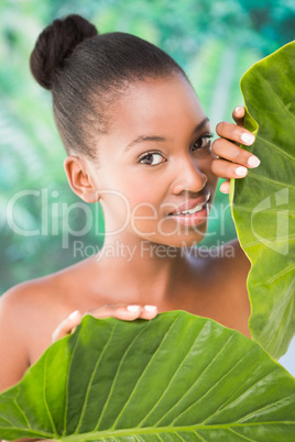 Pretty woman looking through leaves