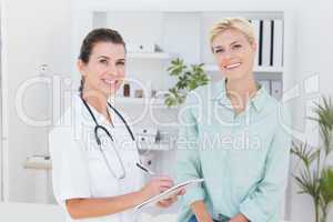 Doctor and patient smiling at camera