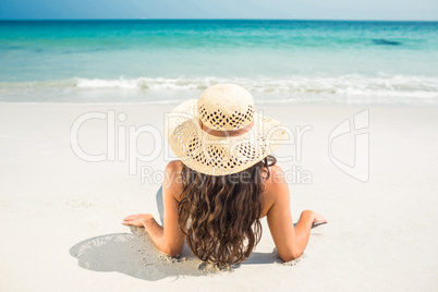 Rear view of pretty brunette looking at the ocean