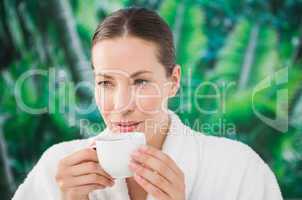Close up portrait of a beautiful young woman drinking a coffee